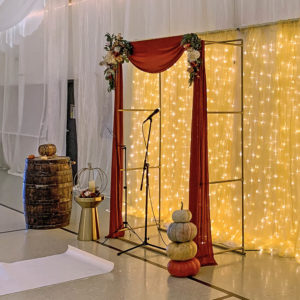 Sami and Donny had a Fall and Gold theme for their wedding. Here is the Gold Ceremony Arch and Gold Lighted Ceremony Backdrop from Smiling Dog Entertainment.