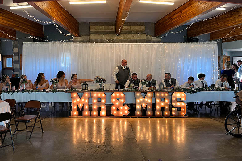 lighted head table backdrop and Mr and Mrs Sign